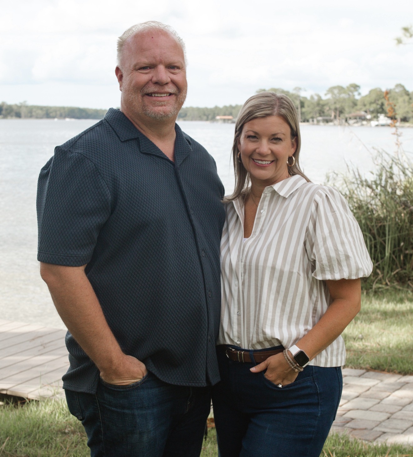 Dave Fowler and his wife outdoors by the water